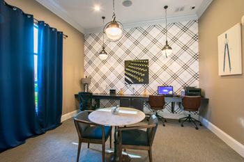 A room with a table and chairs and a patterned wallpaper.